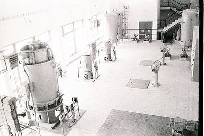 Industrial facility featuring multiple cylindrical tanks and mechanical equipment, likely a dairy or beverage processing plan...