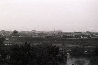 Black-and-white aerial view of the Forbidden City’s northern walls and rooftops, Beijing, China. Traditional Chinese architec...