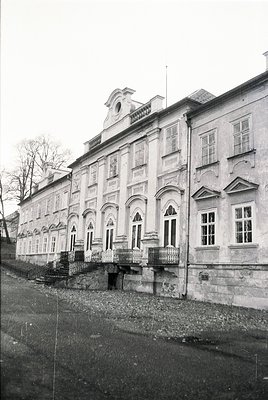 Neoclassical stone building with arched windows and decorative cornices, likely a historic institutional or public structure....