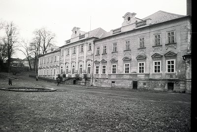 Neoclassical stone building with symmetrical façade, arched windows, and decorative cornices. Likely institutional or public ...