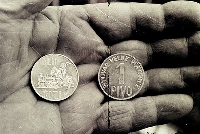 1960s Czechoslovakian 1 Pivo coin (100 Hřivna) held by hand, featuring a locomotive and lion emblem on reverse. Text reads "N...