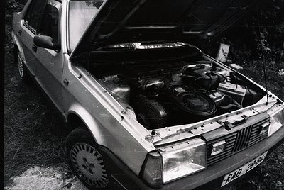 Classic **Volvo 740** with open hood showcasing inline-5 engine, likely **1980s** production. Rust and wear suggest vintage r...