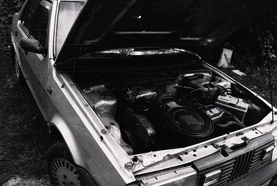 Classic inline-6 engine bay of a vintage European sedan, likely a **Volvo 700/760 series** (1980s). Distinctive Bosch fuel in...