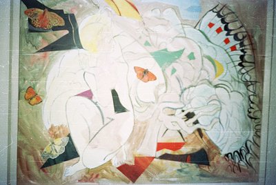 Abstract mural featuring bold geometric shapes, floral motifs, and vibrant colors—predominantly white, red, green, and yellow...