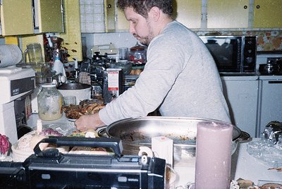 Man prepares food in a mid-century kitchen with vintage appliances, including a toaster oven and jarred ingredients. Yellow c...