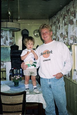 Vintage indoor portrait of a man in a **Hard Rock Café London** T-shirt (1990s) posing with a toddler in a matching shirt. De...