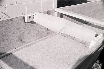 Industrial concrete slab with poured-in-place texture, framed by rough concrete edges and exposed rebar. Likely a mid-century...