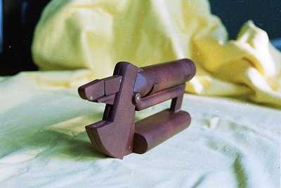 Mid-century modern wooden chair leg detail, showcasing clean lines and tapered cylindrical design. Likely from a vintage or r...