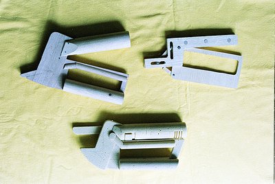 Industrial metal brackets and clamps with bolted joints, likely for structural or mechanical assembly. Clean, unfinished surf...