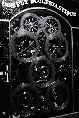 Vintage mechanical "Comput Écclesiastique" device for calculating liturgical cycles, featuring interlocking gears, dials, and...