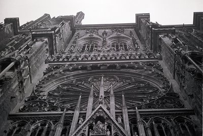 Gothic cathedral façade featuring intricate stone tracery, pointed arches, and sculpted figures. Likely 13th–16th century Eur...