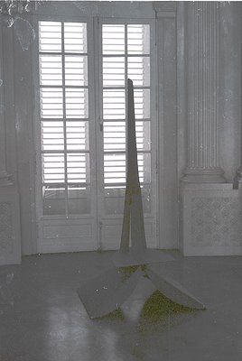 Neoclassical interior featuring tall, open double doors with louvered upper panels and frosted glass lower sections. A single...