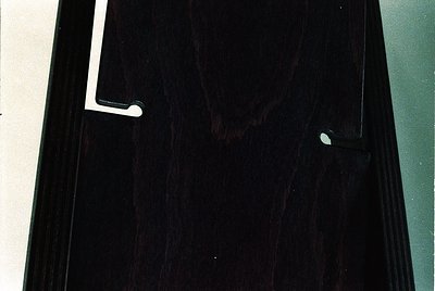 Close-up of a vintage black vinyl record sleeve, featuring a white label with embossed text and a circular logo. The design s...