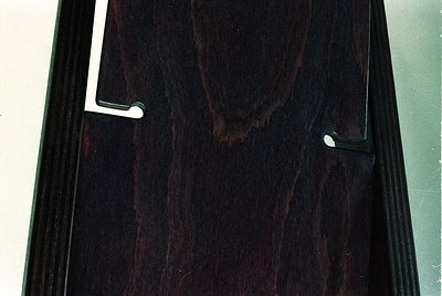 Dark-stained wooden interior door with vertical grain pattern and two metallic handles. Mid-century modern design with clean ...