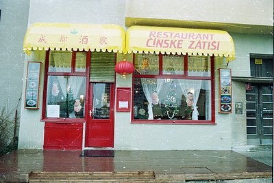 Mid-20th century Chinese-Czech fusion restaurant facade with dual signage: Chinese characters (成都酒家) and Czech (RESTAURANT ČI...