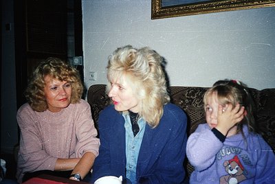 Vintage indoor portrait of three women in a cozy setting, likely 1980s–1990s. Left: woman in a pink sweater, center: older wo...