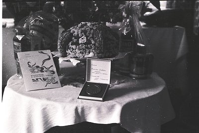 Vintage black-and-white table display featuring a **1960s-era** award box, likely a **gold medal**, inscribed *"Prix de la Vi...