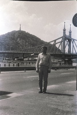 Man in 1960s-style suit stands beside the **Vitosha Bridge (Sofia, Bulgaria)**, a Soviet-era steel arch structure. Industrial...