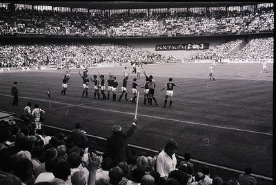 Black-and-white stadium shot of a post-match celebration, likely UEFA Champions League or European Cup era (1960s–1970s). Tea...