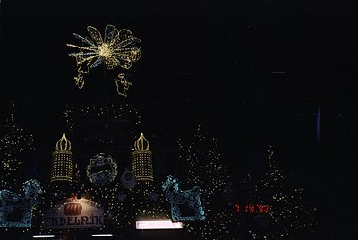 Vibrant nighttime fireworks display featuring intricate floral and dragon motifs. Illuminated Chinese characters "福" (blessin...