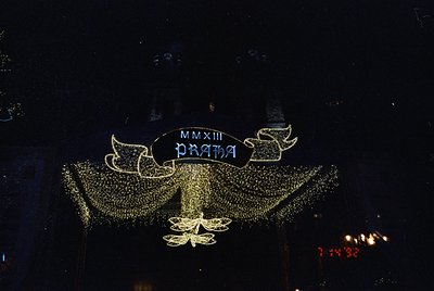 Elaborate illuminated sign featuring Roman numerals "MMXIII" (2013) and "PRAHA" on a decorative, star-studded backdrop. Likel...