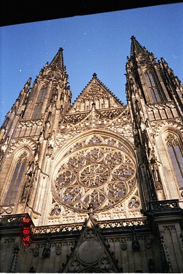 Gothic cathedral façade featuring a grand rose window with intricate stained glass and pointed spires. Architectural details ...