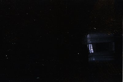 Low-light astrophotography capturing a faint Milky Way with a bright satellite streak. Composition highlights cosmic dust and...