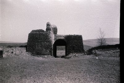 Stone watchtower with arched entrance, likely a historic lookout or defensive structure. Constructed from rough-hewn blocks, ...