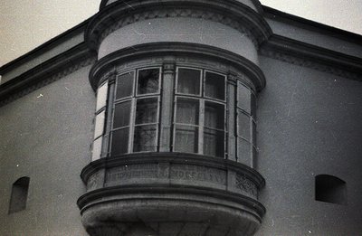 Close-up view of a projecting bay window with ornate detailing. Stone construction, possibly a villa or hotel. Likely early 2...