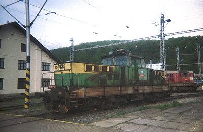 An overhead view depicts a Swiss Electric Locomotive (SBB Re 4/4) series, numbered 10602. It's situated on a rail yard next t...
