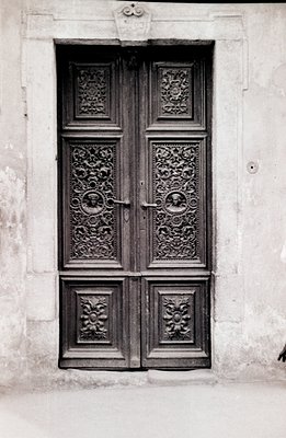 Elaborate, carved wooden doors, likely 18th or 19th century. Detailed floral and figurative relief work adorns the panels. Se...