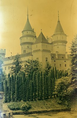 A view of Peleș Castle, Romania, showcasing its distinctive neo-Renaissance architecture and tiered turrets. The building ble...