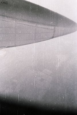 Close-up image reveals a blurred, slightly distressed surface. Possible architectural detail—perhaps a curved wall—is suggest...