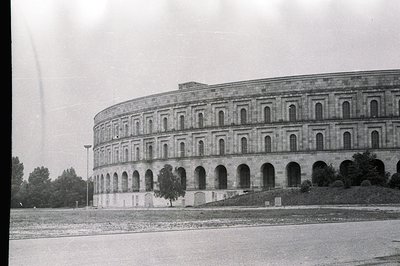 Architectural study of a monumental, curved structure with repetitive arched windows, possibly a gallery or promenade. Formal...