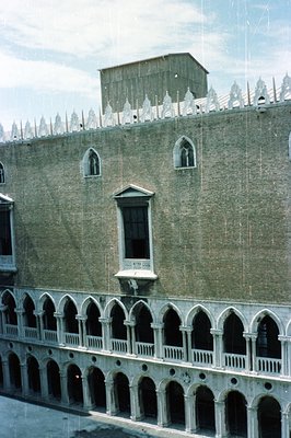 Grand canal façade of the Doge’s Palace in Venice, Italy. Features ornate Gothic tracery on the lower loggia, contrasting wit...