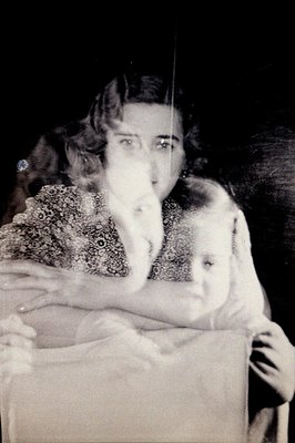 A striking, ghostly image: a woman in a beaded dress holds a child, both blurred by movement. The portrait evokes experimenta...