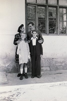 A family portrait, likely 1950s, shows a mother in a plaid dress, a boy in a suit, and a young girl with a satchel. The setti...
