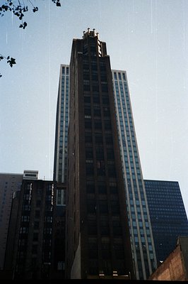 Looking up at the iconic Chicago Board of Trade Building, a masterpiece of early skyscraper architecture. Detailed cornices a...