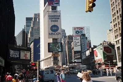 Times Square, NYC, showcasing vintage signage. The Minolta and TDK billboards are prominent, indicative of 1980s consumer tec...