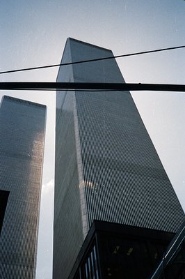 Looking up at the iconic World Trade Center towers in New York City. A low-angle shot showcases the buildings' immense height...