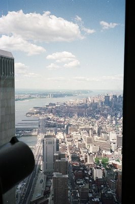 Exterior view from high elevation. Downtown Manhattan cityscape visible across the harbor, including the Statue of Liberty in...
