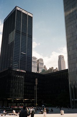 Striking modernist architecture frames a view of New York City skyscrapers. The foreground building exhibits a grid-like faça...