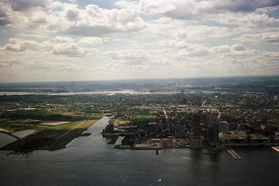 Aerial view of Montreal, Canada, showcasing the St. Lawrence River and cityscape. Prominent skyscrapers define the downtown a...
