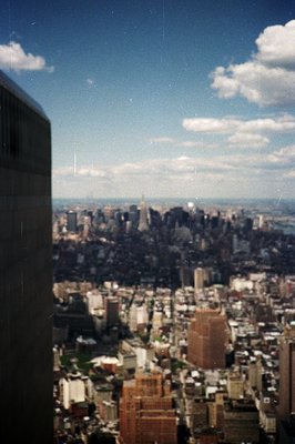High-angle view of lower Manhattan, NY, featuring the Empire State Building & a partial view of the Statue of Liberty. Likely...