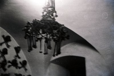 A dramatic, high-angle view captures a multi-tiered chandelier suspended within an arched interior space. The architecture fe...