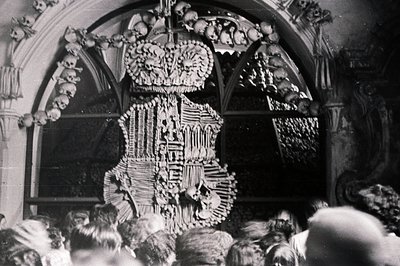 A complex, intricately crafted artwork composed entirely of human bones and skulls dominates the view. Likely a devotional pi...