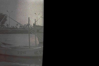 A photograph shows a weathered boat with Cyrillic script ("Курун" and "HC 24") on its side, reflecting a landscape. Tall util...
