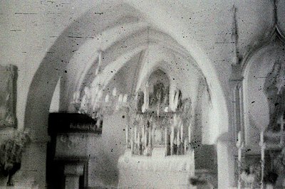 Ornate, vaulted ceiling with a Gothic Revival pipe organ. The architectural details showcase intricate carvings and arches. L...