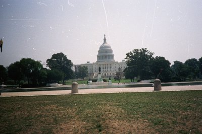 Classic view of the U.S. Capitol Building in Washington, D.C. Lush green lawn and distant monuments lead to the iconic neocla...