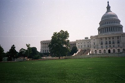 The United States Capitol building dominates the scene with its neoclassical architecture and iconic dome. A wide, manicured ...